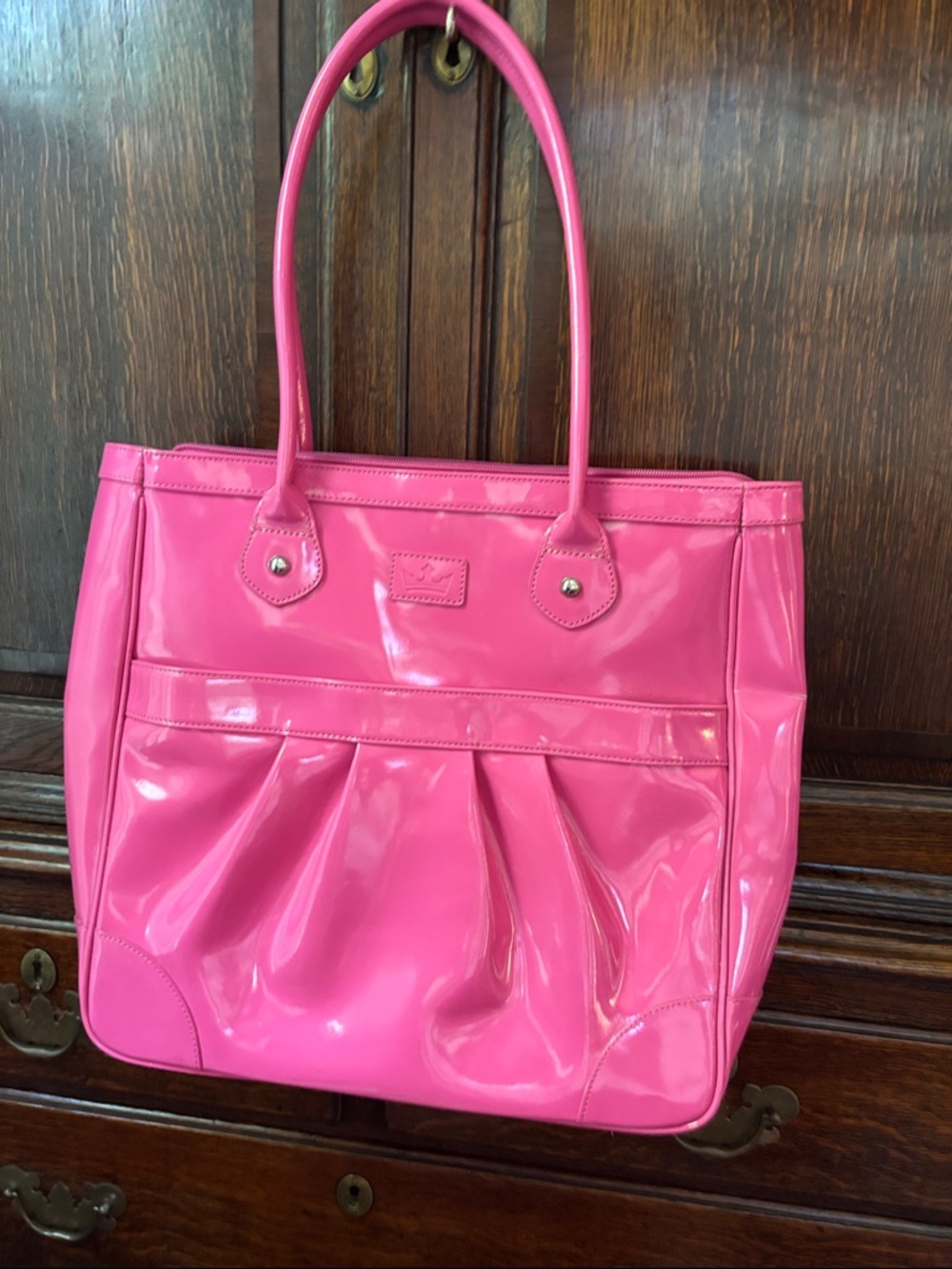 Large pink patent tote with zipper pouch in back; pocket in front